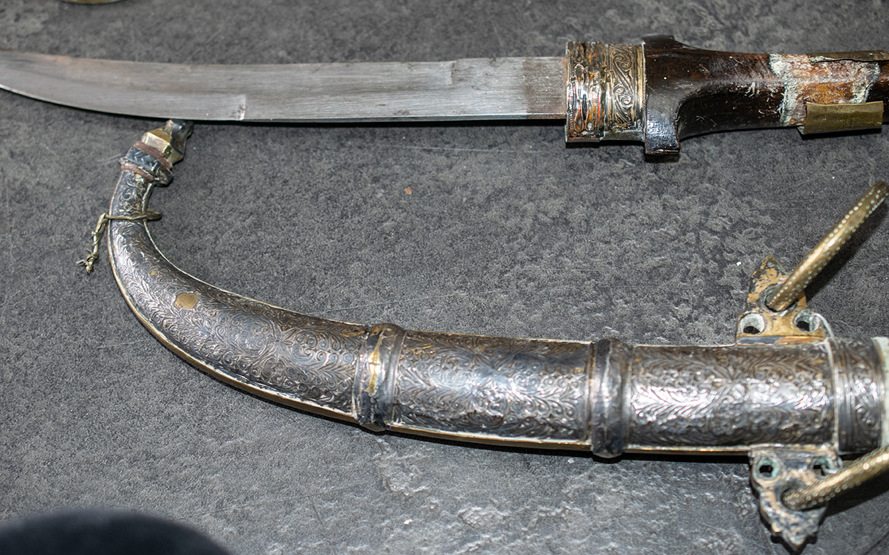 Two Middle Eastern Antique Daggers in brass and copper embossed sheaths, - Image 2 of 4