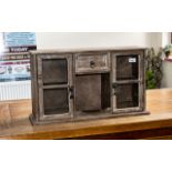 Small Wooden Display Cabinet with two cupboard doors with glass fronts, and a central drawer above a
