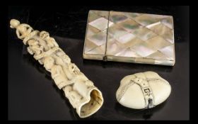 Small Mixed Lot to include: a Mother of Pearl Card Case, a small bone carving with figures,