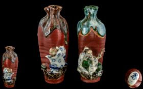 A Pair of Japanese Sumida Gawa Vases of typical form with red glaze, raised figures. height 7.