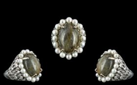 Silver Dress Ring stone set with pearl surround, ornate silver decorative sides. Marked for silver.