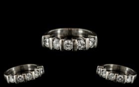 An 18ct White Gold 5 Stone Diamond Ring set with round modern brilliant cut diamonds between baton