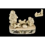 Inuit Walrus Ivory Carving of a Couple and Their Two Dogs Sitting on an Ice Floe with incised,