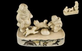 Inuit Walrus Ivory Carving of a Couple and Their Two Dogs Sitting on an Ice Floe with incised,