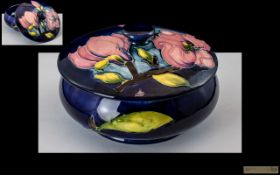 Moorcroft - Fine Quality Lidded Powder Bowl of Round Form. ' Magnolia ' Pink Design on Blue Ground.