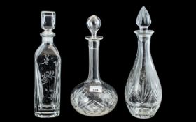 Three Decorative Glass Decanters, one in square form 13" tall with etched decoration,
