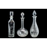 Three Decorative Glass Decanters, one in square form 13" tall with etched decoration,