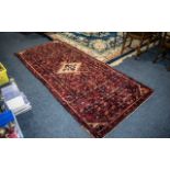 A Genuine Persian Runner, Red Ground, decorated in an all-over floral design on a rich red ground.