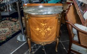 A French Style Bow Fronted Commode with shaped marble top, ormolu mounts and inlaid door.