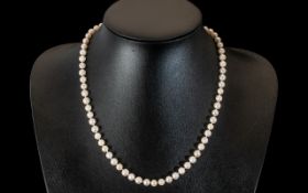 A Cultured Pearl Necklace, with silver gilt clasp, length 19".