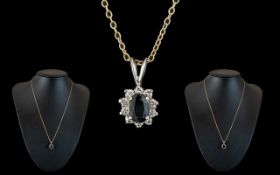 14ct White Gold Attractive Diamond & Sapphire Set Pendant attached to a 9ct gold chain.