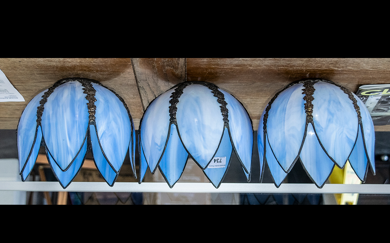 Three Blue Glass Shades, in a bluebell shape with metal floral decoration between petals.