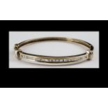 14ct Gold Diamond Hinged Bangle, The Front Set With Channel Set Tapering Baguette Cut Diamonds,