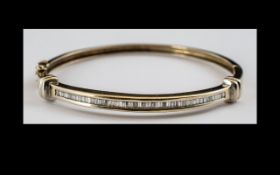 14ct Gold Diamond Hinged Bangle, The Front Set With Channel Set Tapering Baguette Cut Diamonds,