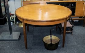 A Round G Plan Teak Extending Table together with two G-plan chairs.