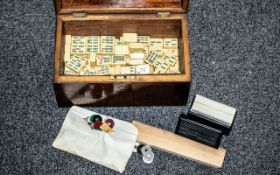 A 19th Century Tea Caddy, containing a Mah Jong set, cards, dice and counters.