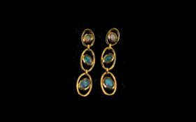 Opal Pair of Triple Drop Earrings, each earring having three graduated, oval cut, opal cabochons,