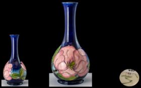 W. Moorcroft Signed Globular Shaped Vase with Tall Neck ' Magnolia ' Pink Design on Blue Ground. c.