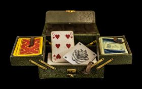 A Gaming Set For Bridge comprising two packs of playing cards and a set of score cards,