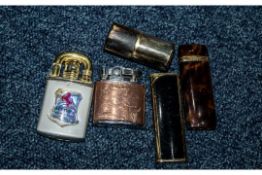 Collection of Five Cigarette Lighters, assorted styles. Including Yves Saint Laurent, and a trench