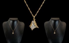 An 18ct Diamond Set Pendant, set with round modern brilliant cut diamonds, stylised fan shape,