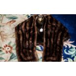 Two Mink Stoles, comprising a dark brown mink wrap stole,