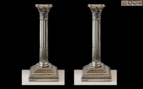 A Fine Pair of Sterling Silver Classical Corinthian Column - Square Based Candlesticks of Pleasing
