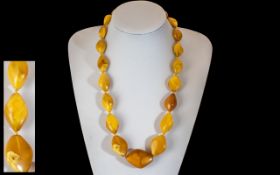 1920's Nice Quality Egg Yolk Amber Necklace (knotted) of excellent colour with screw clasp.