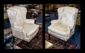 Two Antique Wing Back Armchairs, upholstered in cream embossed damask fabric,