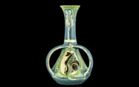 C H Brannam Art Pottery Three Handled Vase, of waisted form, in blue and green pastels with panels
