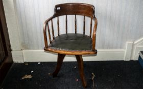 Antique American Oak Swivel Desk Chair of typical form, supported on three shaped legs, with a green