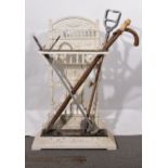 Victorian cast iron stick stand, two shooting sticks and two walking sticks
