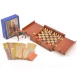 An early 20th Century mahogany cased travel chess set, with full set of pieces, brass hinges, etc