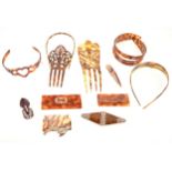 Twelve faux tortoiseshell hair bands, combs, brooches clips, mostly Art Deco, 1930s