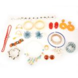 A collection of vintage celluloid, bakelite, plastic fun jewellery.