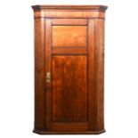 Late Georgian oak and mahogany corner cupboard,