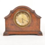 A walnut and brass mantel clock