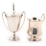 A silver trophy cup and a silver christening cup