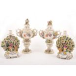 Pair of Continental vases and covers, and a pair of Chelsea style bocage candlesticks