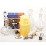 Three cut glass decanters and selection of bottle openers, corkscrews, and kitchenalia.