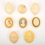 Eight ivorine celluloid cameo style brooches, some French.