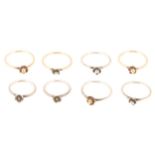 Eight silver and 9 carat gold stacking rings.