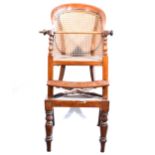 A Victorian mahogany and cane high-chair.