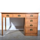 An oak single pedestal desk.