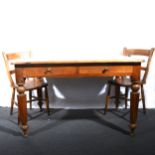 A pine kitchen table, and two beech and elm kitchen chairs.