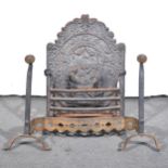 An antique fire basket, with arched cast iron fireback.
