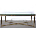 A modern brass finish and plate glass coffee table.