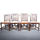 Four Victorian oak dining chairs, three balloon backs, and another chair.