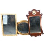 A Chippendale style mahogany mirror, a brass framed mirror, and another.
