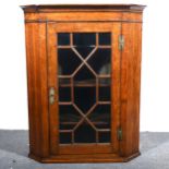 An oak hanging corner cupboard.